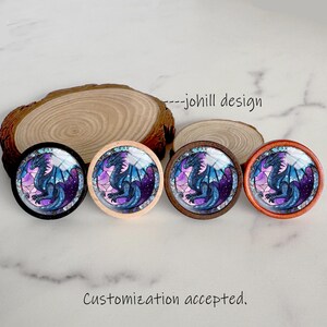 May include: Four round decorative buttons with a dragon design in shades of blue, purple, and pink. The buttons have different colored frames: black, natural wood, dark brown, and orange. The text "---johill design" is visible. The text "Customization accepted." is also visible.