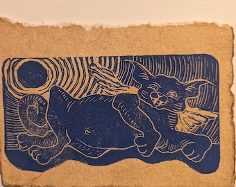 May include: Blue ink print on brown paper of a cat lying on its side with its head turned to the right. The cat has a large, round belly and a long tail. The background is a swirling pattern.