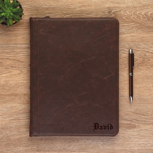 May include: A brown leather bound journal with the name "David" embossed on the front cover.