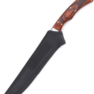 May include: A black leather sheath with a brown wooden handle knife with a silver blade.