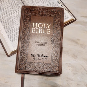 May include: A brown leather-bound Holy Bible with gold lettering. The Bible is personalized with "The Wilsons" and "July 12, 2024".