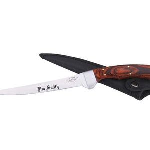 May include: A stainless steel filleting knife with a wood handle. The knife has a curved blade and is engraved with the name "Jim Smith". The knife is in a black leather sheath.