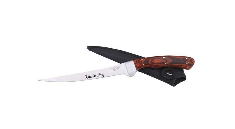 May include: A stainless steel filleting knife with a wood handle. The knife has a curved blade and is engraved with the name "Jim Smith". The knife is in a black leather sheath.