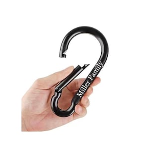 May include: Black metal carabiner with a silver inscription that reads "Miller Family".