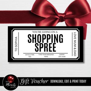 May include: A black and white gift voucher with the text "YOU'RE GOING ON A SHOPPING SPREE". The voucher has a white border and is tied with a red ribbon. The text "TO SOPHIA" and "LOVE MUM & DAD" are also visible.