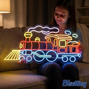 May include: A neon train sign in red, orange, yellow, and blue. The sign depicts a classic steam engine with a smokestack, windows, and wheels. The sign is held by a person.