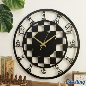 May include: Black and white chess-themed wall clock. The clock features a circular design with chess piece cutouts around the edge and a checkered pattern in the center. Gold-colored hands indicate the time. The clock is displayed on a white wall.