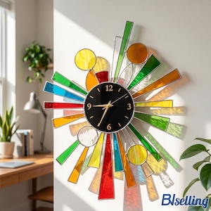 May include: A wall clock featuring a circular black face with gold hands and numerals at 3, 6, 9, and 12. The clock is surrounded by a sunburst design of multi-colored stained glass panels in red, orange, yellow, green, and blue, with circular accents.