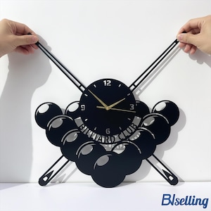 May include: Black wall clock with a billiard theme. The clock features a round face with gold hands and the text "BILLIARD CLUB". The clock is surrounded by billiard balls and cues.