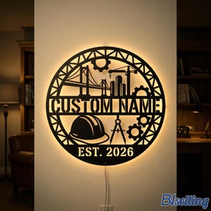 May include: A circular black metal wall sign with backlighting featuring a construction theme. The design includes a bridge, a crane, gears, a hard hat, and a drafting compass. The text reads CUSTOM NAME and EST. 2026 in a bold, stencil-style font.