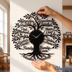 May include: A black wall clock shaped like a family tree with gold hands. The branches feature names including Grandpa John, Grandma Sarah, Dad Michael, Mom Lisa, Brother David, and Sister Anna, with the words Family, Love, Ancestors, and Heritage.