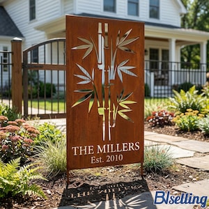 a wooden sign with a bamboo design, standing in front of a house with a garden. The sign has the text "THE MILLERS Est. 2010" on it.
