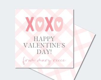 May include: A Valentine's Day card with a pink and white plaid background. The card features the text "XOXO" with heart-shaped designs, and "HAPPY VALENTINE'S DAY!" in gray. The card also includes the text "from mary reece".