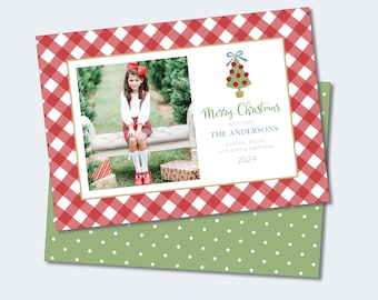 May include: A red and white gingham Christmas card with a photo of a young girl sitting on a bench. The card has a green Christmas tree with red ornaments and a blue bow. The text on the card reads "Merry Christmas with love, The Andersons, Andrew, Eloise and Emma Kathryne, 2024".