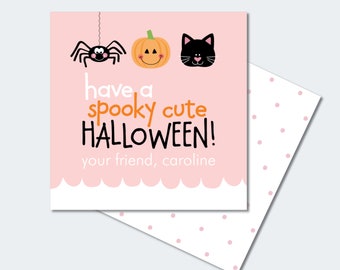 Può includere: Carta stampabile rosa con un'illustrazione di un ragno, una zucca e un gatto nero. La carta dice "have a spooky cute HALLOWEEN! your friend, caroline".