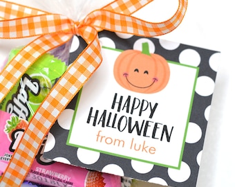 May include: A Halloween-themed gift bag with a clear cellophane wrapper tied with an orange and white checkered ribbon. The tag features a smiling pumpkin and the text "Happy Halloween from Luke."