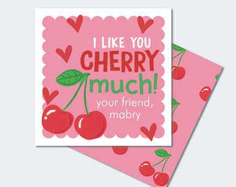 May include: A pink card with a white border and scalloped edges. The card features a cartoon illustration of two red cherries with green leaves and the text "I like you cherry much! your friend, mabry".