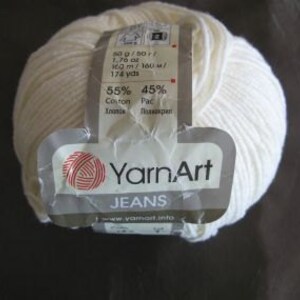 May include: A ball of white YarnArt Jeans yarn, a cotton and acrylic blend. The label reads "55% Cotton 45% Acrylic" and "100m/160m/174 yds".