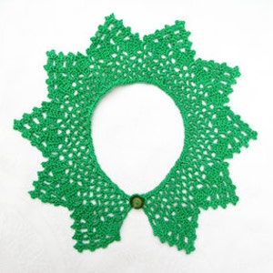 May include: A green crocheted collar with a button closure. The collar is made with a delicate lace pattern.