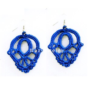 May include: A pair of blue crocheted earrings with a delicate, intricate design. The earrings are made with a fine thread and have a dangling, teardrop shape.