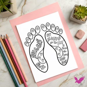 May include: A black and white coloring page featuring two foot outlines with the text "ROMANS 10:15" and "HOW BEAUTIFUL are the FEET of those who bring GOOD NEWS". The page is on a pink background with colored pencils.