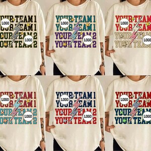 May include: Cream-colored t-shirts with the text "YOUR TEAM 1", "YOUR TEAM 2", and a lightning bolt graphic. The shirts feature a round logo placeholder and star accents. The text and accents are in various colors.
