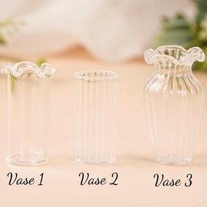 May include: Three clear glass vases with distinct designs. Vase 1 has a ruffled top, Vase 2 is cylindrical with vertical lines, and Vase 3 has a flared shape with a ruffled top. The text "Vase 1", "Vase 2", and "Vase 3" are below each vase.