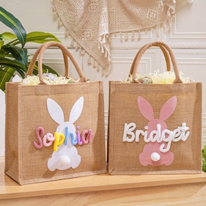 May include: A set of three ceramic mugs with a speckled, matte finish. The mugs are in shades of cream, light gray, and dark gray. Each mug has a simple, minimalist design and a rounded handle. The mugs are stacked on top of each other.