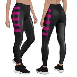 May include: Black leggings with vertical magenta stripes on the side. The leggings are made of a shiny material and are shown from multiple angles. The leggings are paired with black athletic shoes.
