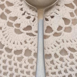 May include: A silver spoon with a crown and the letters "GR" engraved on the handle.