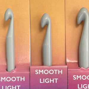 May include: Three gray crochet hooks with the words "Smooth Light" printed on the packaging.