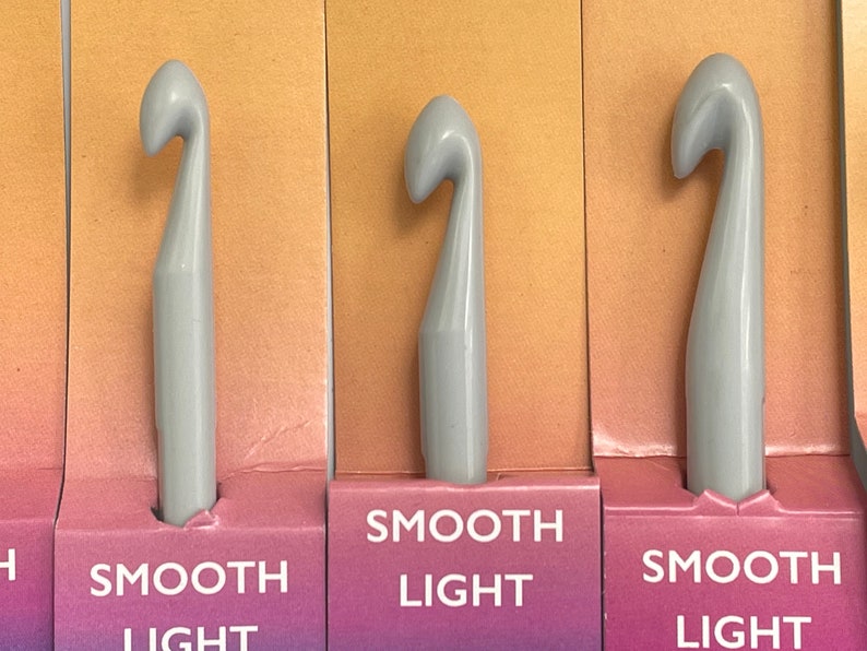 May include: Three gray crochet hooks with the words "Smooth Light" printed on the packaging.