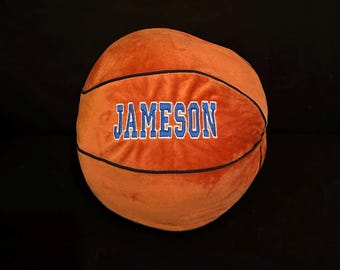 May include: Orange plush basketball with black stitching and the name "JAMESON" embroidered in blue.
