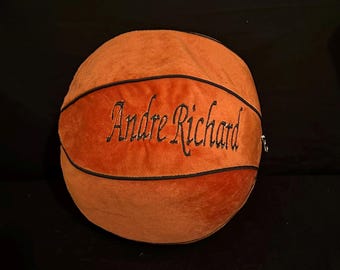 May include: Orange and black plush basketball with the name "Andre Richard" embroidered on it.