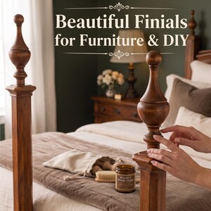 May include: Two tall, turned wooden finials with a smooth, polished finish sit atop square posts. The text "Beautiful Finials for Furniture & DIY" is displayed above. A small jar labeled "Walnut Wood Stain" and a brush are visible on the bed.