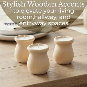 May include: Three wooden candle holders with white candles. The holders are light-colored wood with a rounded shape. The text in the image says "Stylish Wooden Accents to elevate your living room, hallway, and entryway spaces."