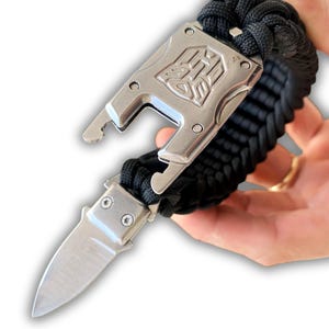 Braccialetto di sopravvivenza in paracord fatto a mano – Fibbia a forma di coltello Transformers per missioni tattiche