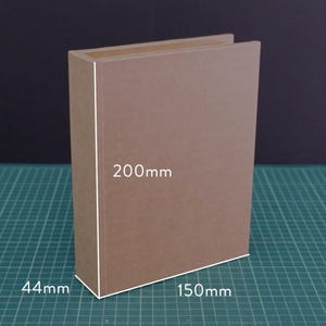 May include: A brown rectangular box with dimensions labeled: 200mm high, 150mm wide, and 44mm deep. The box is made of a light brown material and is positioned on a green surface.