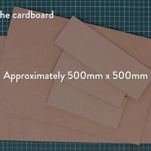 May include: Several pieces of brown cardboard are arranged on a green grid surface. The text "Amount of the cardboard" and "Approximately 500mm x 500mm" are visible in white text.