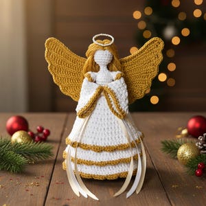 May include: A handcrafted crochet angel figurine with white and gold accents. The angel has golden wings, a halo, and a white dress with gold trim. Decorative ribbons hang from the dress. The angel is a Christmas or holiday decoration.
