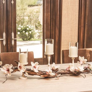 Driftwood Centerpiece: Floral Magnolia, Ivory Hurricane Candle Holders