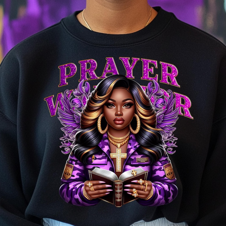 May include: A black sweatshirt with a purple and gold design featuring a woman with a bible and the text "PRAYER WARRIOR".
