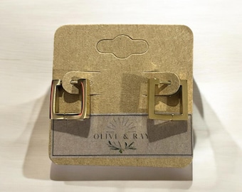 May include: A pair of gold square hoop earrings on a brown card with the text "Olive & Ray".