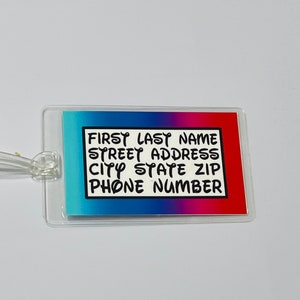 May include: A clear plastic luggage tag with a blue, pink and red gradient background. The tag has a black border and white text that reads "FIRST LAST NAME STREET ADDRESS CITY STATE ZIP PHONE NUMBER".