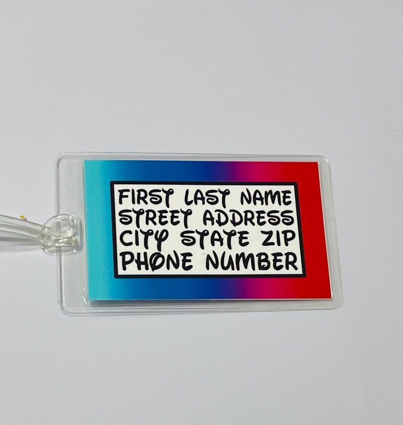 May include: A clear plastic luggage tag with a blue, pink and red gradient background. The tag has a black border and white text that reads "FIRST LAST NAME STREET ADDRESS CITY STATE ZIP PHONE NUMBER".