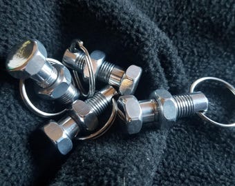 Keyring, keychain, keys, zipper pulls, zippers, lanyards, nut bolt, captured nut bolt, aluminum bolt, brass bolt,