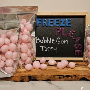 May include: Pink bubble gum taffy in clear plastic bags. The bags are labelled "Freeze Please" and "Bubble Gum Taffy".