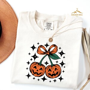 Comfort Colors® Halloween Pumpkin Cherries Shirt, Coquette Bow Pumpkin Shirt, Womens Halloween Gift, Fall Pumpkin Shirt, Cute Autumn Gift