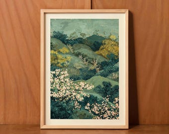 May include: Framed art print featuring a landscape scene with rolling hills in shades of teal, gold, and green. The artwork includes white floral accents and is set within a light wood frame. The overall aesthetic is reminiscent of a serene, natural environment.