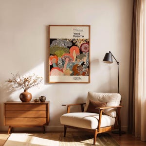 Yayoi Kusama-inspired art poster displayed leaning on the wall, showcasing a vibrant design on a natural wood frame.